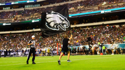 Fan running with Eagles flag