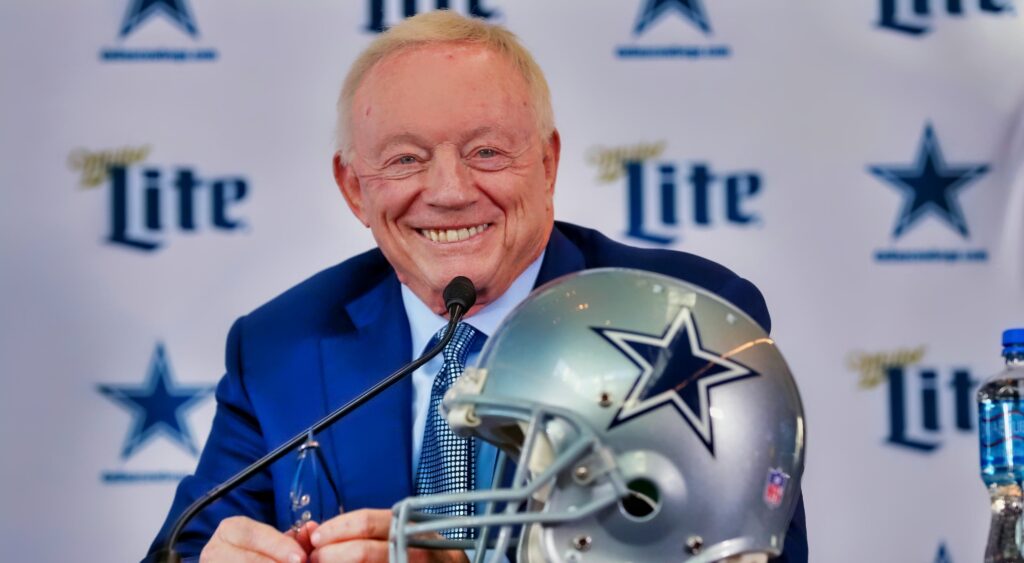 Jerry Jones smiles at a press conference.