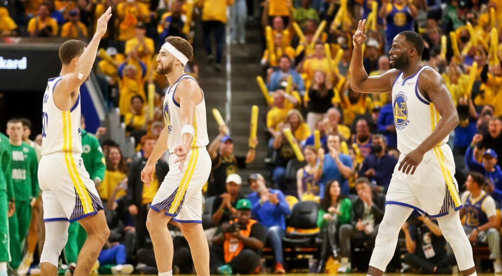 Golden State Warriors stars Stephen Curry (left), Klay Thompson (middle) and Draymond Green (right) celebrating.