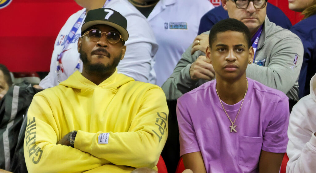 Carmelo Anthony sitting next to his son Kiyan