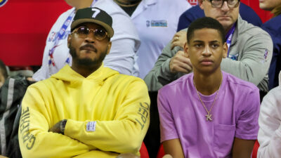 Carmelo Anthony sitting next to his son Kiyan