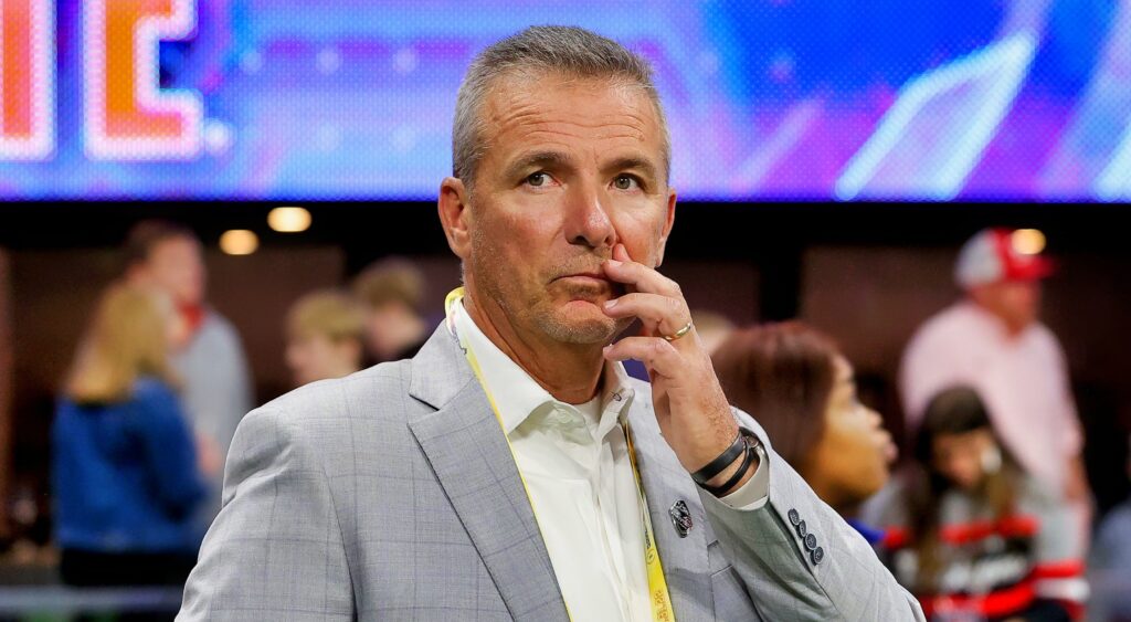 Forme NCAA football and NFL coach Urban Meyer looking on.