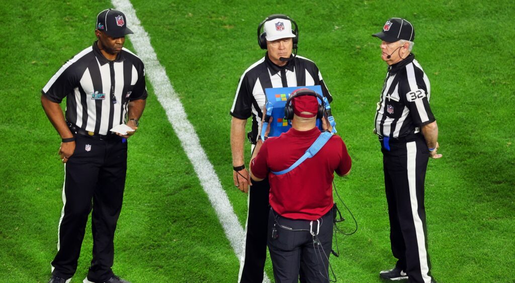 NFL Refs gather during a review.