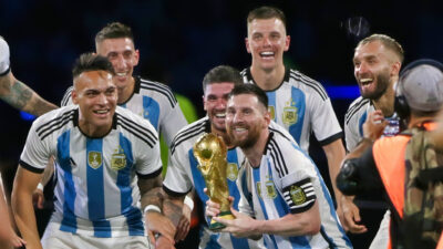 Lionel Messi holding World Cup trophy