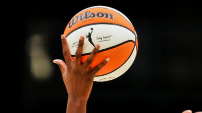 WNBA basketball on player's hand