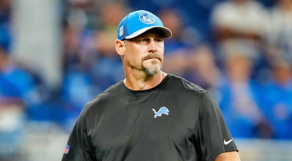 Detroit Lions' head coach Dan Campbell looking on.