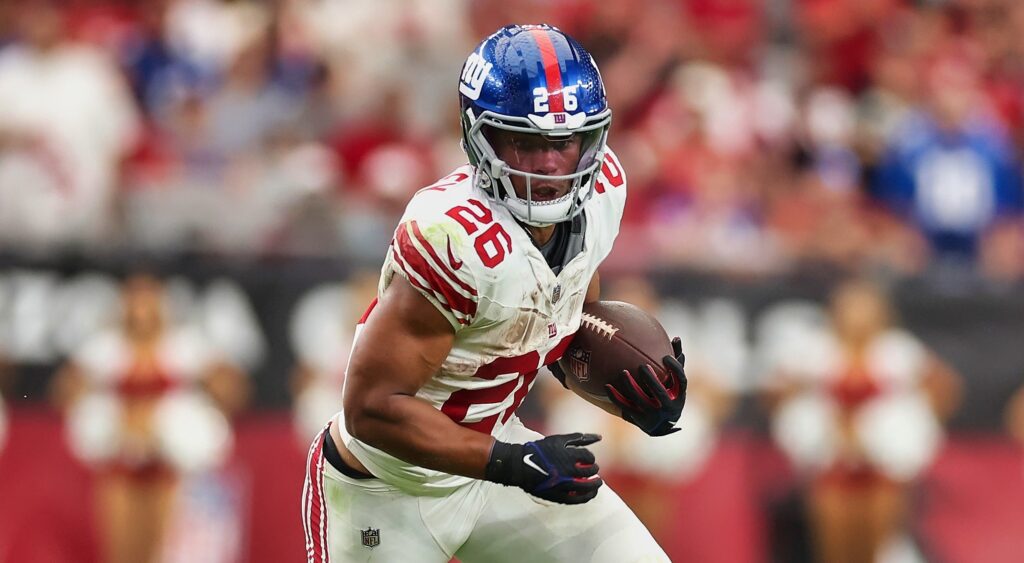 New York Giants' star Saquon Barkley running with football.