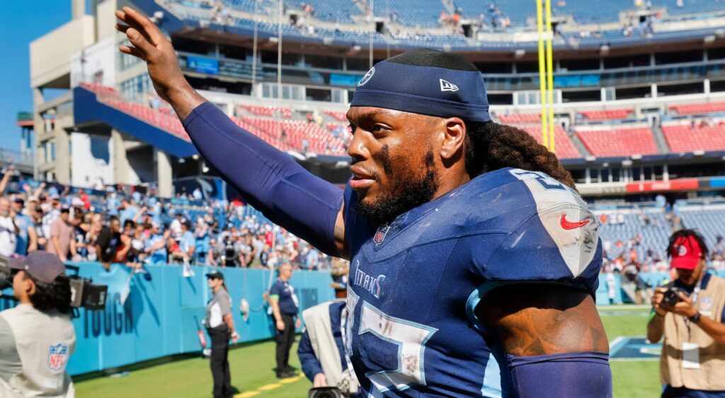 Derrick Henry of Tennessee Titans waving while walking off field.