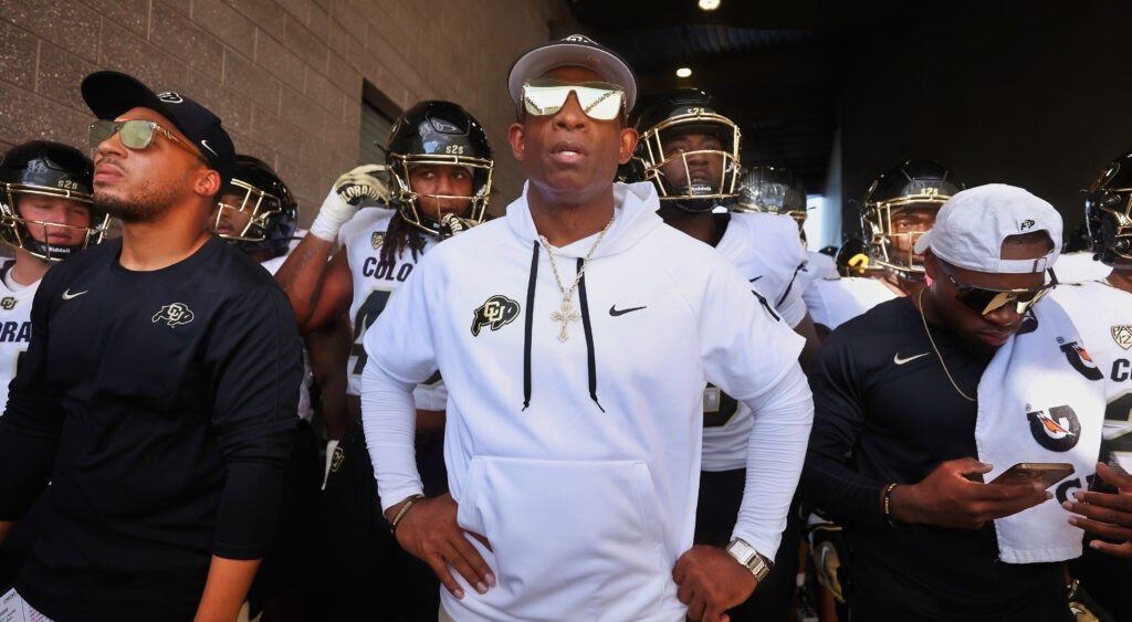 Deion Sanders standing in front of Colorado players