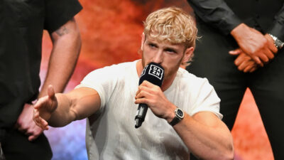 Logan Paul speaking into a mic and gesturing