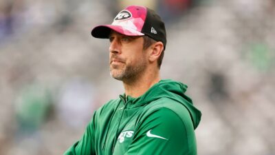 Aaron Rodgers in Jets hoodie and cap