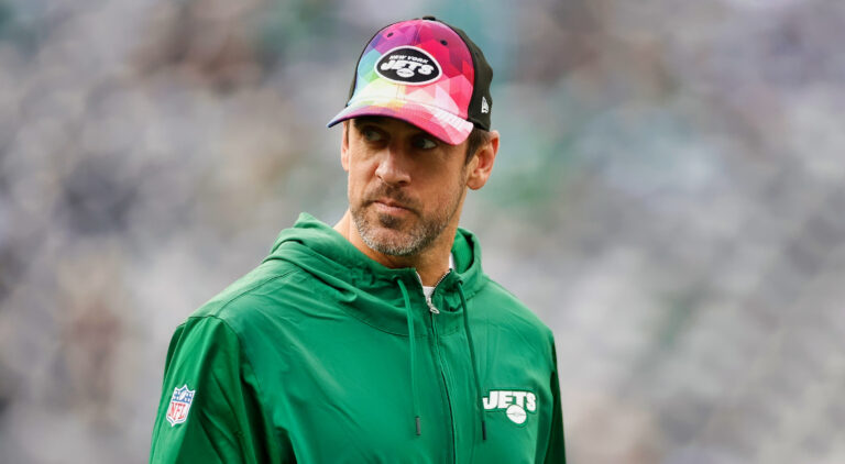 Aaron Rodgers in Jets sweater and cap