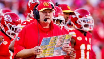 Andy Reid holding play-sheet on sidelines