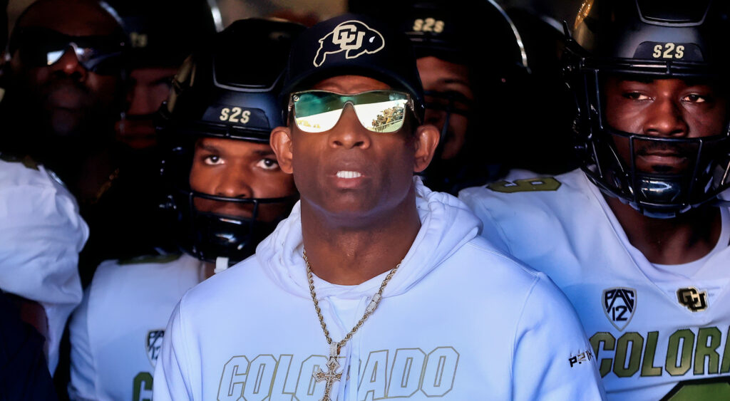 Deion Sanders standing in front of Colorado Buffaloes players