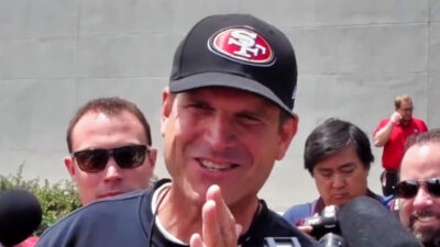 Jim Harbaugh speakign to reporters