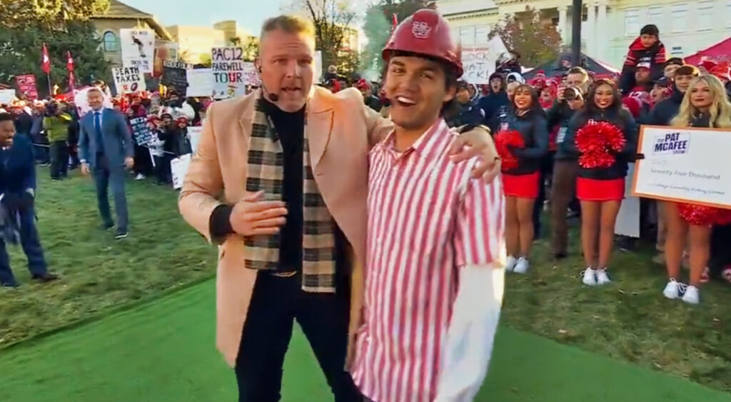 Pat McAfee holding a student from Utah