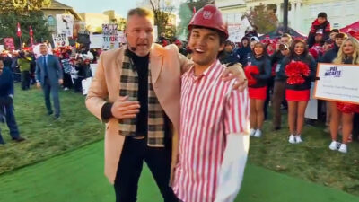 Pat McAfee holding a student from Utah