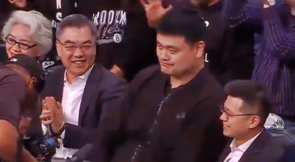 Yao Ming sitting courtside at NBA game