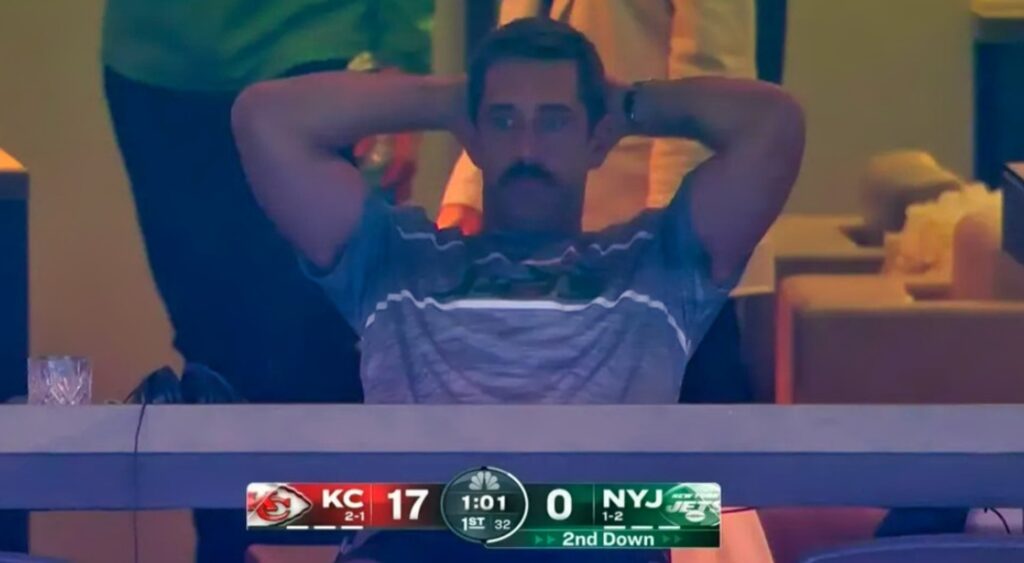 Aaron Rodgers with arms behind his head