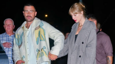 Travis Kelce holding hands with Taylor Swift
