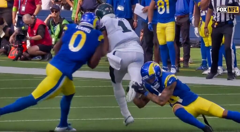 Jalen Hurts being hit by Rams players