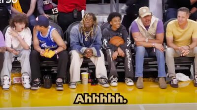 Lil Wayne sitting courtside with son