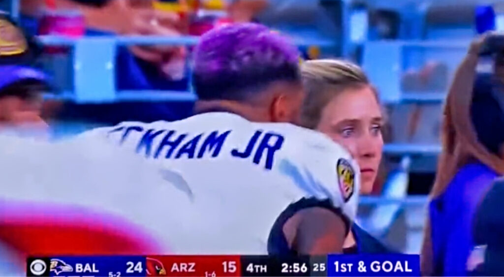 Odell and woman on sidelines