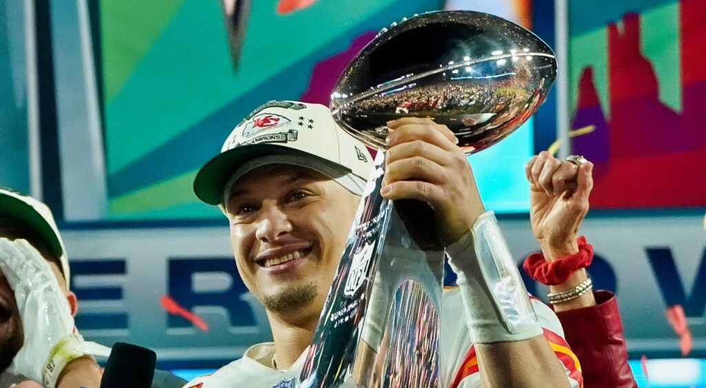 Patrick Mahomes holding up Super trophy.