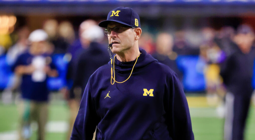 Jim Harbaugh with a whistle in his mouth