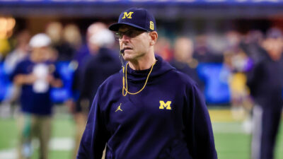 Jim Harbaugh with a whistle in his mouth