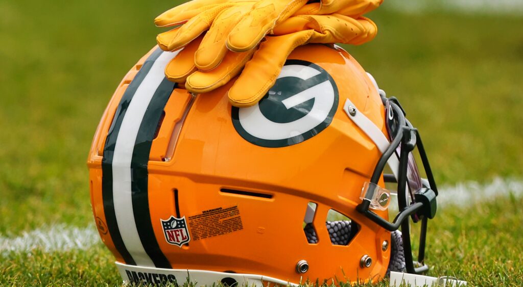 Yellow gloves on packers helmet