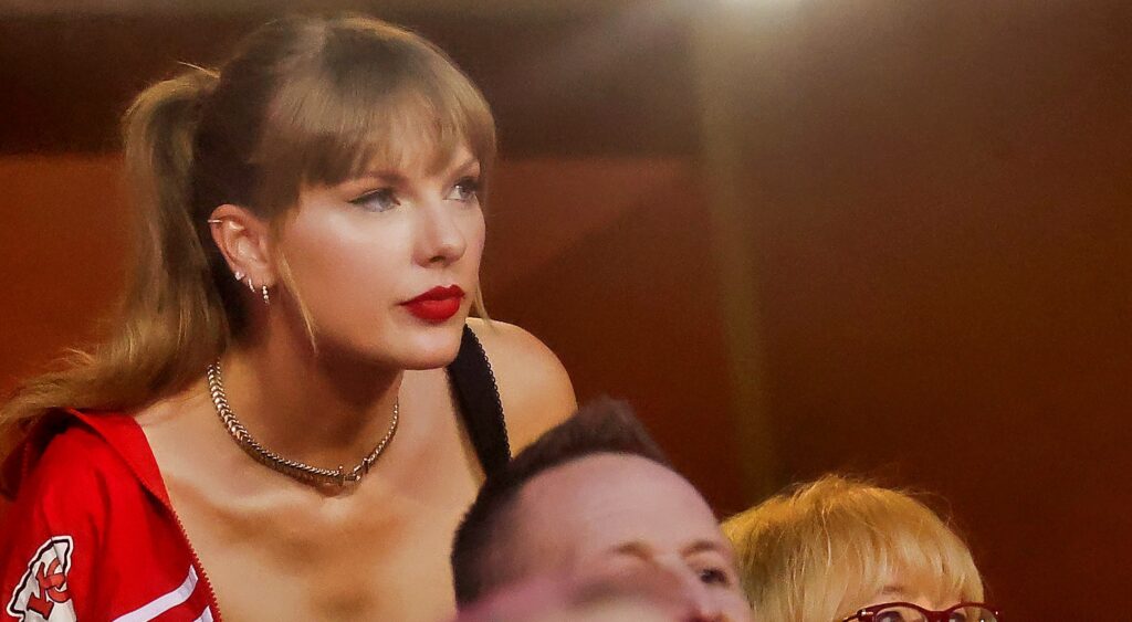 Taylor Swift looking out of suite window during nfl game