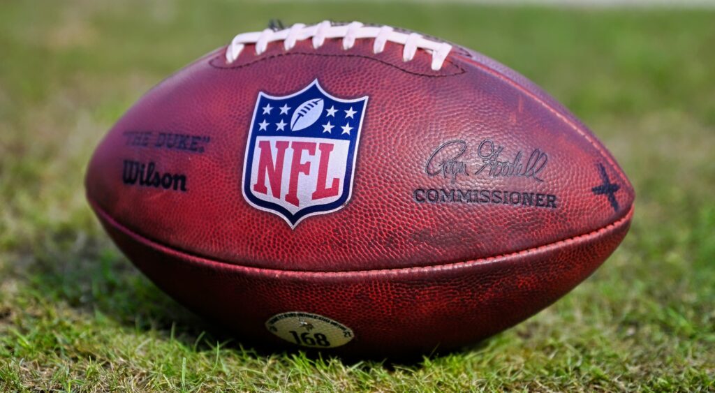 NFL logo on a football shown on field.