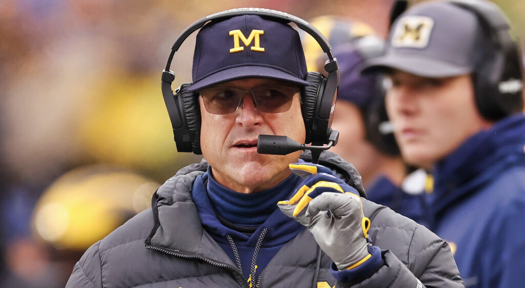 Jim Harbaugh speaking into a headset