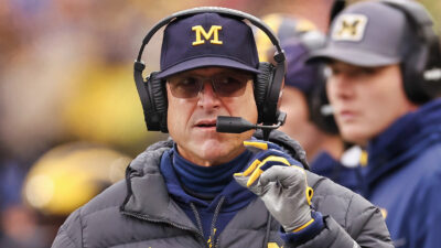 Jim Harbaugh speaking into a headset