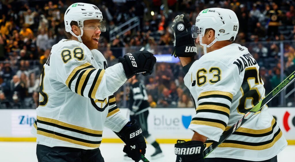 David Pastrnak (left) celebrating a goal with Brad Marchand (right).