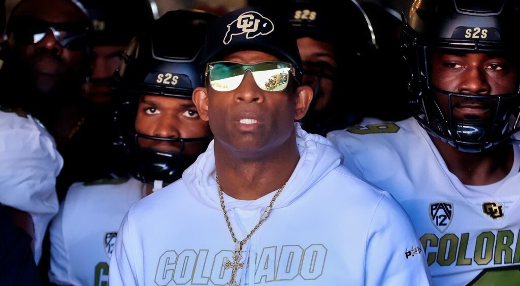 Deion Sanders looks on from the tunnel.