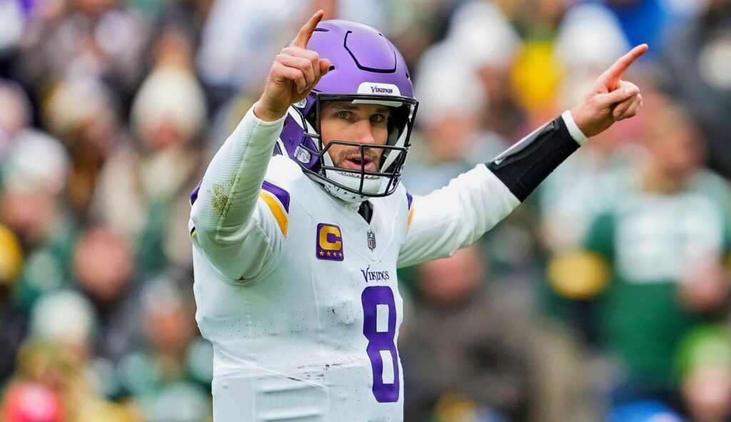 Kirk Cousins points after throwing a touchdown.