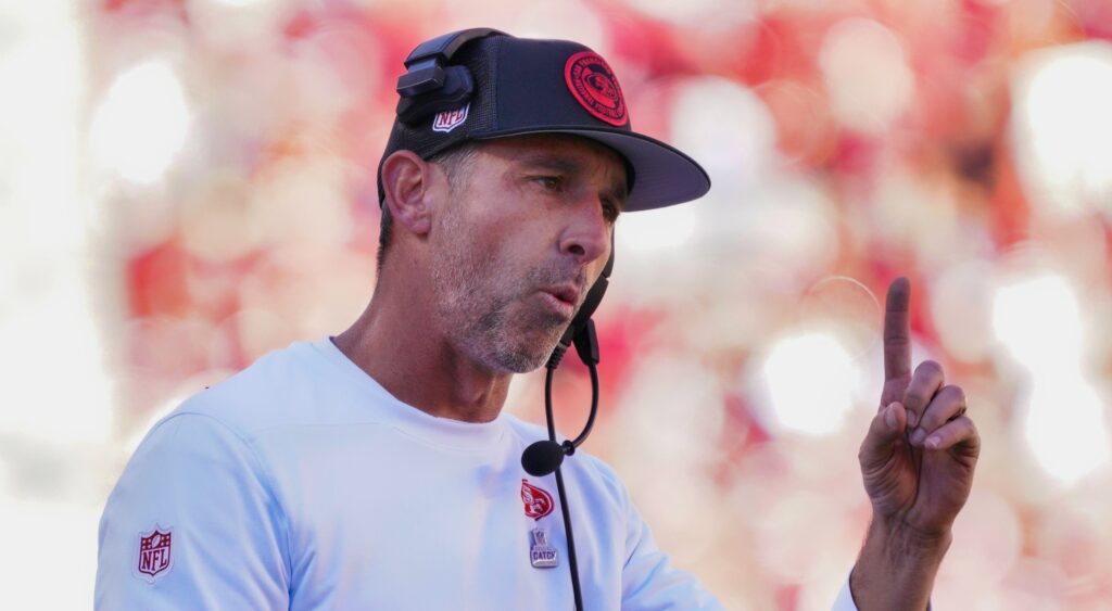 San Francisco 49ers Kyle Shanahan points finger up while looking on.