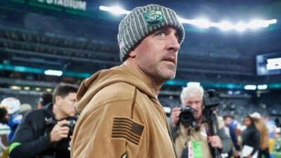 Aaron Rodgers in Jets gear and hoodie