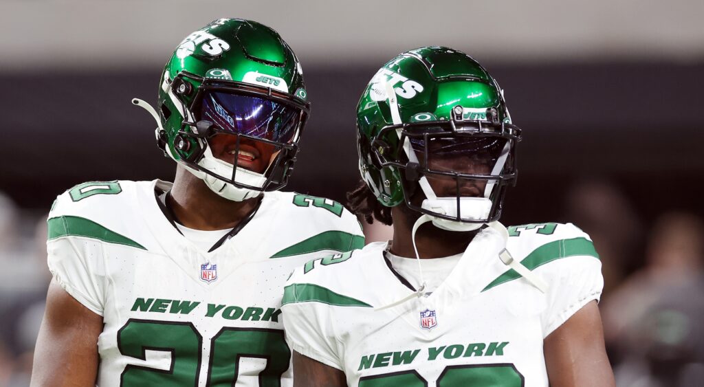 Breece Hall (left) and Michael Carter (right) of New York JEts looking on.