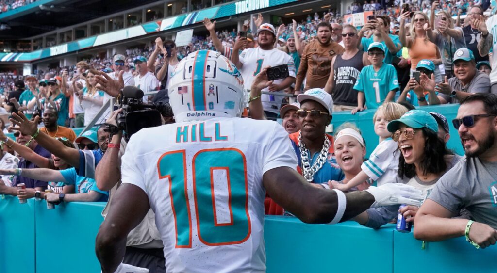Miami Dolphins wide receiver Tyreek Hill celebrating a touchdown with fans.