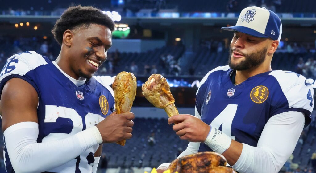 DaRon Bland and Dak Prescott each holding a turkey leg