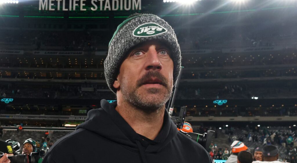 Aaron Rodgers of New York Jets looking on while walking off field.