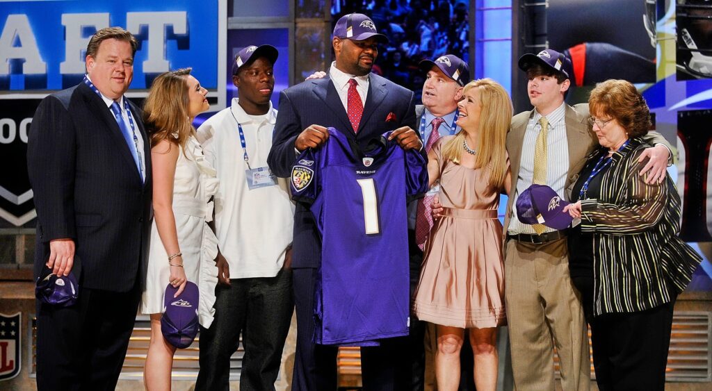 Michael Oher and the Tuohy family on the draft stage.