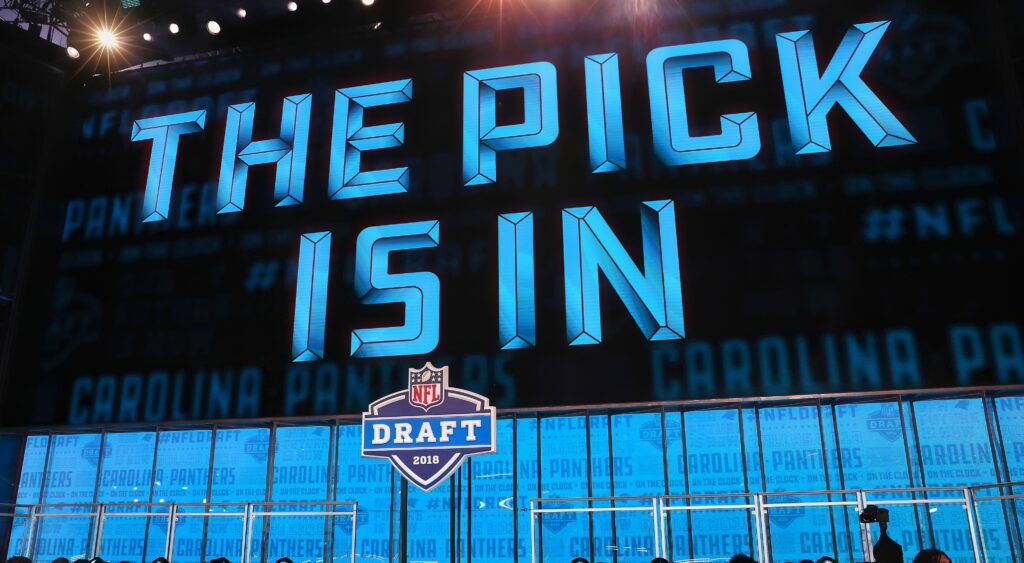 Big screen saying "The Pick Is In" at the NFL Draft.