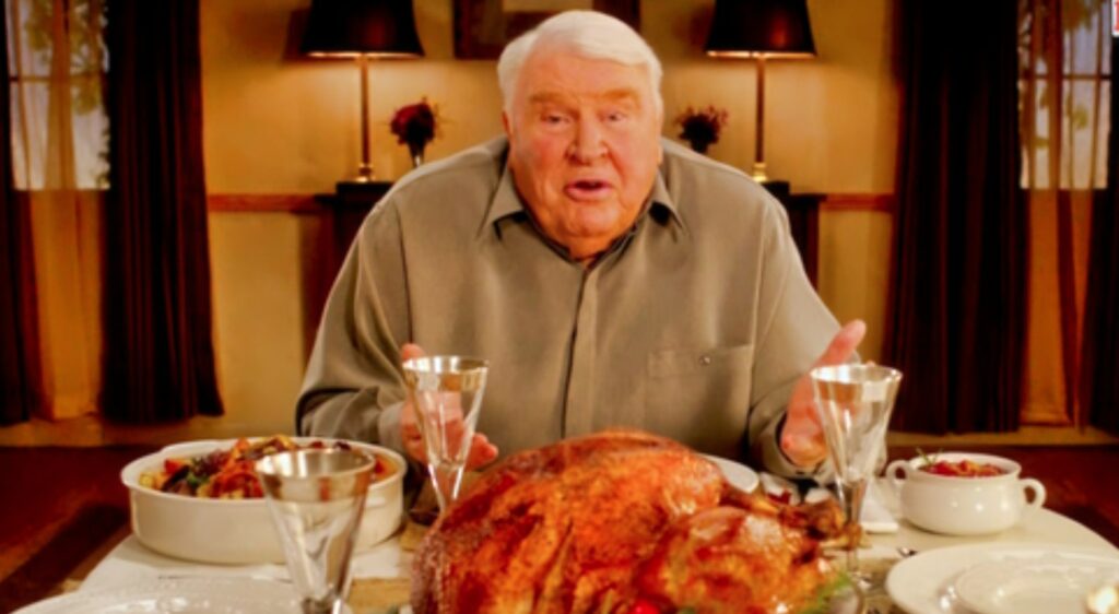 John Madden sits down to eat Thanksgiving dinner.