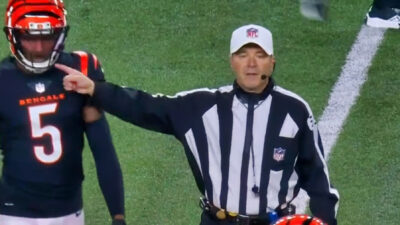 NFL ref with a finger close to Tee Higgins