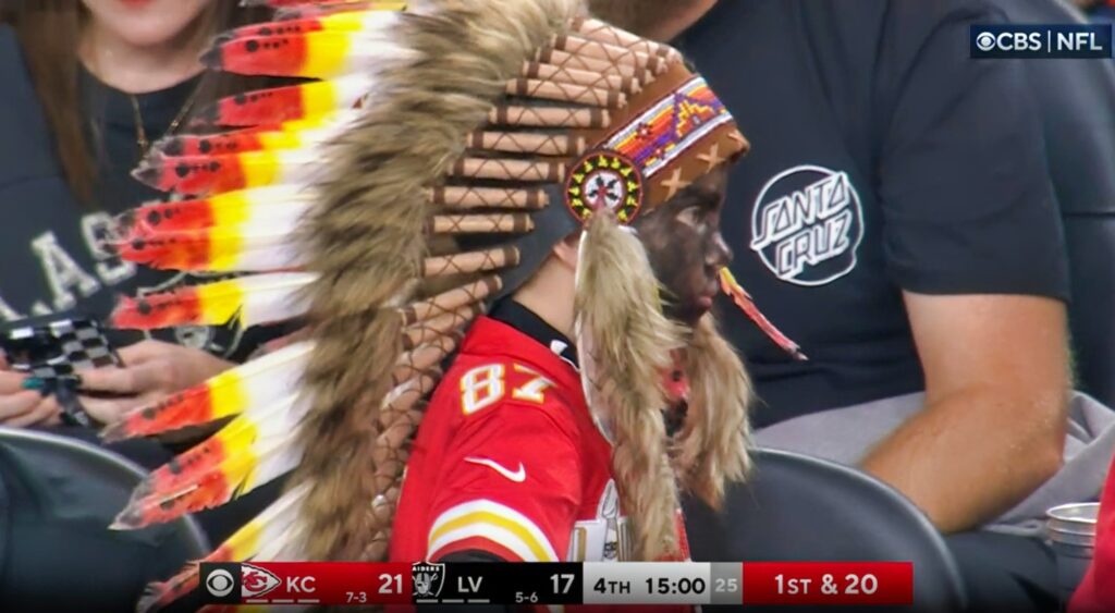 Young boy wearing headdress at Chiefs game