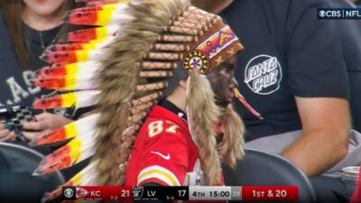 Young boy wearing headdress at Chiefs game